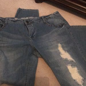 Women destroyed studded jeans